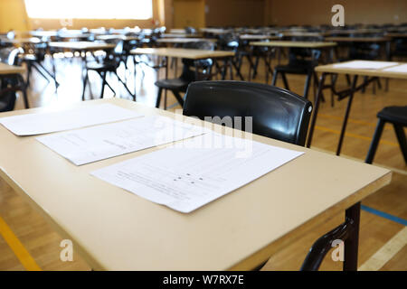 exam examination room or hall set up ready for students to sit test. multiple desks tables and chairs. Education, school, student life concept. test e Stock Photo