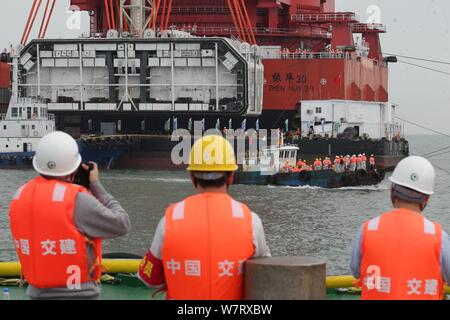 Workers install the final piece of the 5,664-meter-long undersea tunnel of the Hong Kong-Zhuhai-Macao Bridge under construction in Zhuhai city, south Stock Photo