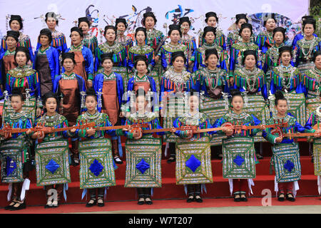 Chinese participants from the Dong ethnic minority play Pipa or Chinese lute during a music competition held in Zhuguan village, Liping county, Qiando Stock Photo