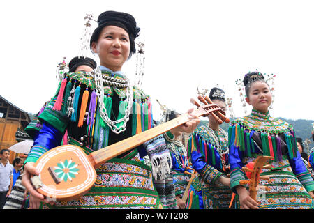 Chinese participants from the Dong ethnic minority play Pipa or Chinese lute during a music competition held in Zhuguan village, Liping county, Qiando Stock Photo