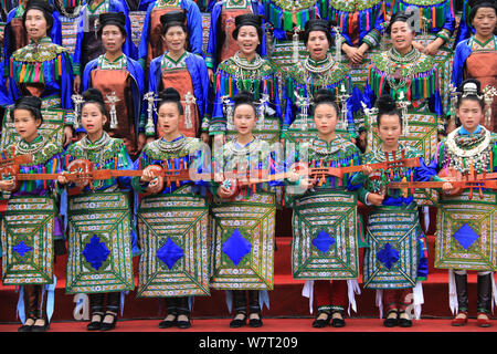 Chinese participants from the Dong ethnic minority play Pipa or Chinese lute during a music competition held in Zhuguan village, Liping county, Qiando Stock Photo