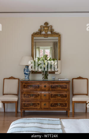 Antique drawers under mirror in bedroom Stock Photo