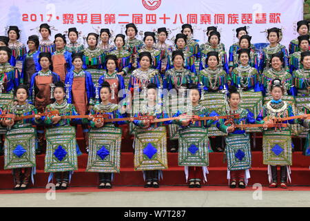 Chinese participants from the Dong ethnic minority play Pipa or Chinese lute during a music competition held in Zhuguan village, Liping county, Qiando Stock Photo