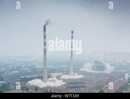 Two 180-meter-tall chimneys and a cooling tower are demolished by explosion at Nanjing No.2 Thermal Power Plant in Nanjing city, east China's Jiangsu Stock Photo