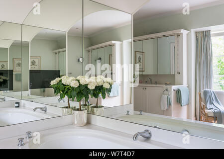 Mirrors over bathtub in country style bathroom Stock Photo