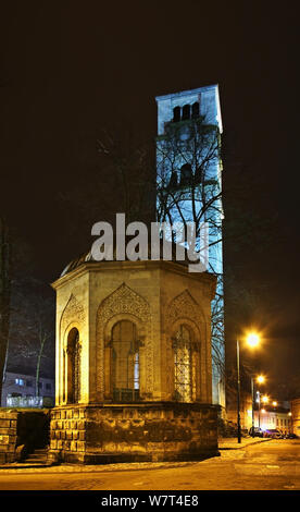 Ottoman tomb and Church of St. Antun – clock tower (Sahat kula) in Bihac. Bosnia and Herzegovina Stock Photo