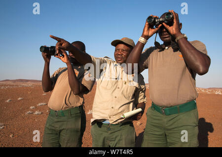 Save the Rhino Trust trackers (l-r) Denso Tjiraso, Martin Nawaseb, Epson Rukuma at Desert Rhino Camp, Wilderness Safaris, Kunene region, Namibia, May 2013 Stock Photo