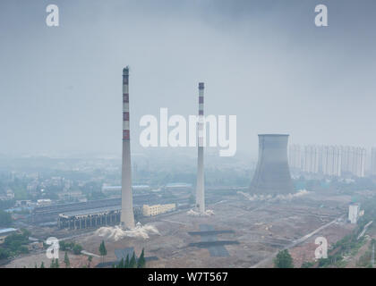 Two 180-meter-tall chimneys and a cooling tower are demolished by explosion at Nanjing No.2 Thermal Power Plant in Nanjing city, east China's Jiangsu Stock Photo