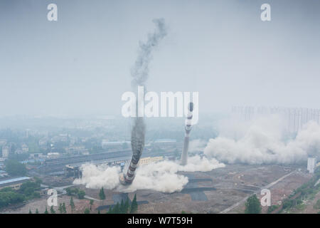 Two 180-meter-tall chimneys and a cooling tower are demolished by explosion at Nanjing No.2 Thermal Power Plant in Nanjing city, east China's Jiangsu Stock Photo