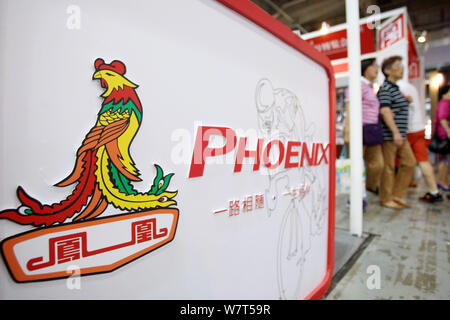 --FILE--People visit the stand of bicycle maker Phoenix during an exhibition in Shanghai, China, 26 September 2014.   Phoenix, a 120-year-old bike pro Stock Photo