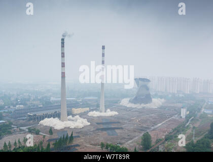 Two 180-meter-tall chimneys and a cooling tower are demolished by explosion at Nanjing No.2 Thermal Power Plant in Nanjing city, east China's Jiangsu Stock Photo