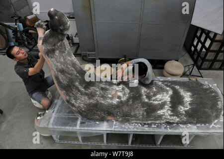 Xie Yong, Professor Xie Yong of Shenyang University, makes an otter sculpture made out of 300,000 sewing needles at his studio in Shenyang city, north Stock Photo