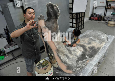 Xie Yong, Professor Xie Yong of Shenyang University, makes an otter sculpture made out of 300,000 sewing needles at his studio in Shenyang city, north Stock Photo