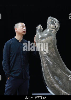 Xie Yong, Professor Xie Yong of Shenyang University, strokes the otter sculpture made by him out of 300,000 sewing needles in Shenyang city, northeast Stock Photo