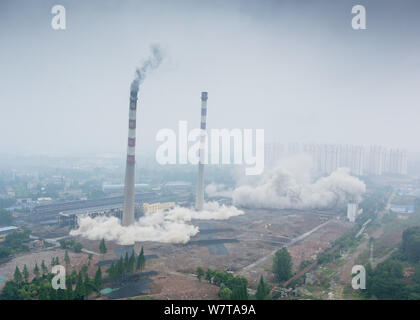 Two 180-meter-tall chimneys and a cooling tower are demolished by explosion at Nanjing No.2 Thermal Power Plant in Nanjing city, east China's Jiangsu Stock Photo