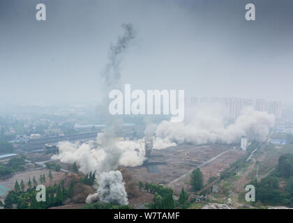 Two 180-meter-tall chimneys and a cooling tower are demolished by explosion at Nanjing No.2 Thermal Power Plant in Nanjing city, east China's Jiangsu Stock Photo