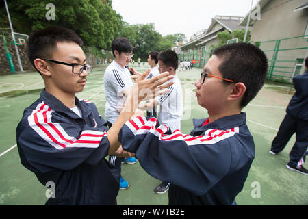 Chinese students at the high school attached to Zhejiang University are taught by martial art Wing Chun teacher Jiang Hanlong in Hangzhou city, east C Stock Photo