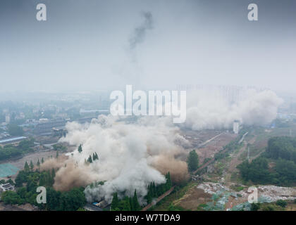 Dense smoke spreads after two 180-meter-tall chimneys and a cooling tower were demolished by explosion at Nanjing No.2 Thermal Power Plant in Nanjing Stock Photo