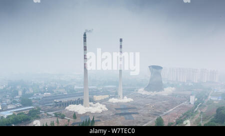 Two 180-meter-tall chimneys and a cooling tower are demolished by explosion at Nanjing No.2 Thermal Power Plant in Nanjing city, east China's Jiangsu Stock Photo