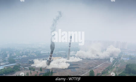 Two 180-meter-tall chimneys and a cooling tower are demolished by explosion at Nanjing No.2 Thermal Power Plant in Nanjing city, east China's Jiangsu Stock Photo