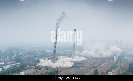 Two 180-meter-tall chimneys and a cooling tower are demolished by explosion at Nanjing No.2 Thermal Power Plant in Nanjing city, east China's Jiangsu Stock Photo