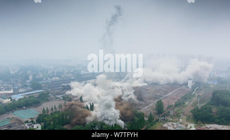 Two 180-meter-tall chimneys and a cooling tower are demolished by explosion at Nanjing No.2 Thermal Power Plant in Nanjing city, east China's Jiangsu Stock Photo