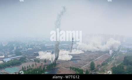 Two 180-meter-tall chimneys and a cooling tower are demolished by explosion at Nanjing No.2 Thermal Power Plant in Nanjing city, east China's Jiangsu Stock Photo