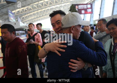 Chinese veteran soldier Wang Qi, front, who was unable to leave India for 54 years, is pictured at the Xi'an Xianyang International Airport before ret Stock Photo