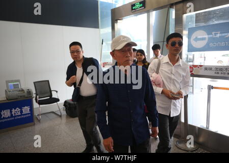 Chinese veteran soldier Wang Qi, center, who was unable to leave India for 54 years, is pictured at the Xi'an Xianyang International Airport before re Stock Photo