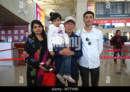 Chinese veteran soldier Wang Qi, second right, who was unable to leave India for 54 years, is pictured at the Xi'an Xianyang International Airport bef Stock Photo