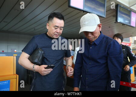 Chinese veteran soldier Wang Qi, right, who was unable to leave India for 54 years, is pictured at the Xi'an Xianyang International Airport before ret Stock Photo