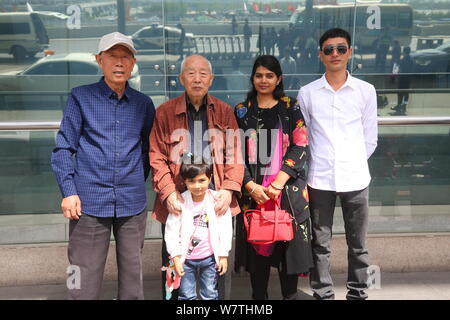 Chinese veteran soldier Wang Qi, left, who was unable to leave India for 54 years, is pictured at the Xi'an Xianyang International Airport before retu Stock Photo