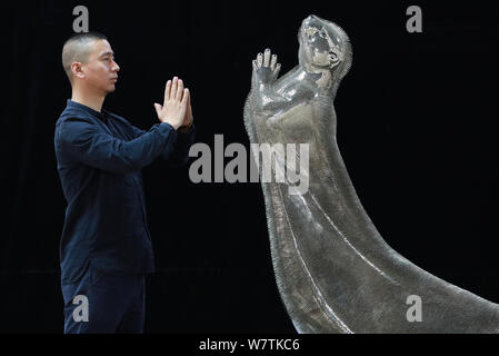 Xie Yong, Professor Xie Yong of Shenyang University, poses in front of the otter sculpture made by him out of 300,000 sewing needles in Shenyang city, Stock Photo