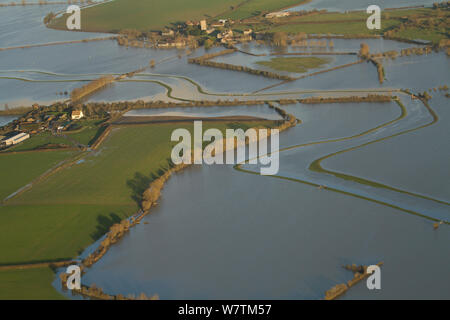 Muchelney village (with church and abbey) during January 2014 floods, showing flooded River Parrett, Somerset Levels, England, UK, 9th January 2014. Stock Photo