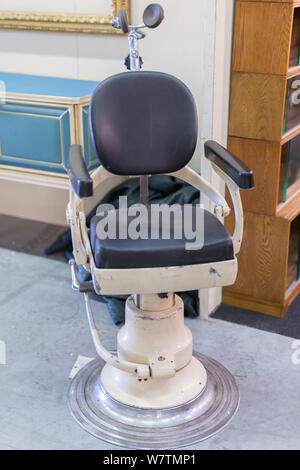 Antique Black Dentist Leather Chair with Headrest. Stock Photo