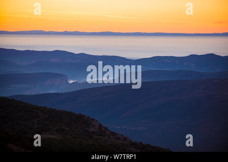 Fog in valley of Montsec mountains at sunrise. Pre-Pyrenees, Lleida, Catalonia, Spain, December 2012. Stock Photo