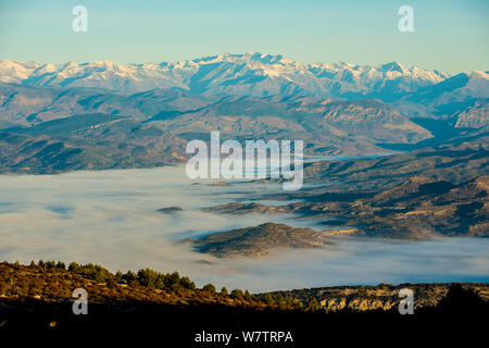 Fog in the valley, Montsec mountains at sunrise. Pre-Pyrenees, Lleida, Catalonia, Spain, December 2012. Stock Photo