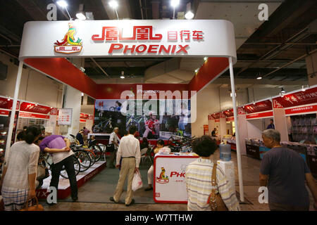 --FILE--People visit the stand of bicycle maker Phoenix during an exhibition in Shanghai, China, 26 September 2014.   Phoenix, a 120-year-old bike pro Stock Photo