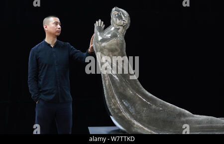 Xie Yong, Professor Xie Yong of Shenyang University, strokes the otter sculpture made by him out of 300,000 sewing needles in Shenyang city, northeast Stock Photo