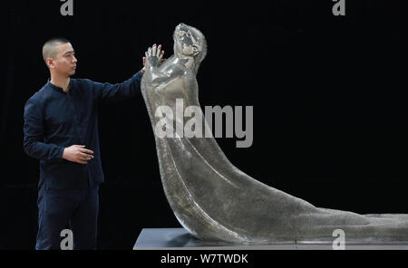 Xie Yong, Professor Xie Yong of Shenyang University, strokes the otter sculpture made by him out of 300,000 sewing needles in Shenyang city, northeast Stock Photo