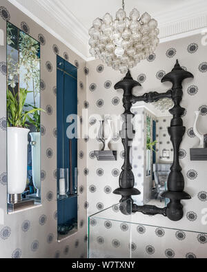 Mirror on patterned wallpaper Stock Photo