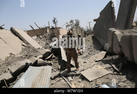 Kabul, Afghanistan. 7th Aug, 2019. Afghan security force members inspect at the site of the explosion in Kabul, capital of Afghanistan, Aug. 7, 2019. At least 95 people were wounded after a massive car bomb explosion ripped through a busy neighborhood at the western side of Afghanistan's capital Kabul on Wednesday, an official said. Credit: Rahmatullah Alizadah/Xinhua/Alamy Live News Stock Photo