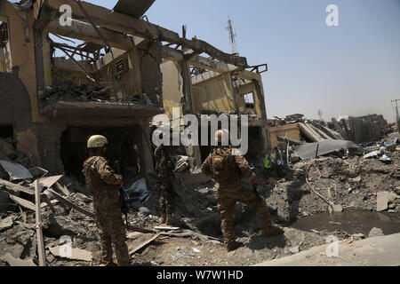 Kabul, Afghanistan. 7th Aug, 2019. Afghan security force members inspect at the site of an explosion in Kabul, capital of Afghanistan, Aug. 7, 2019. At least 95 people were wounded after a massive car bomb explosion ripped through a busy neighborhood at the western side of Afghanistan's capital Kabul on Wednesday, an official said. Credit: Rahmatullah Alizadah/Xinhua/Alamy Live News Stock Photo