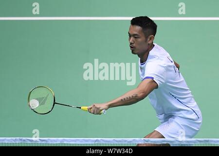 Lin Dan of China returns a shot to Lee Dong-keun of South Korea in their first round match of the men's singles during the 2017 Badminton Asia Champio Stock Photo