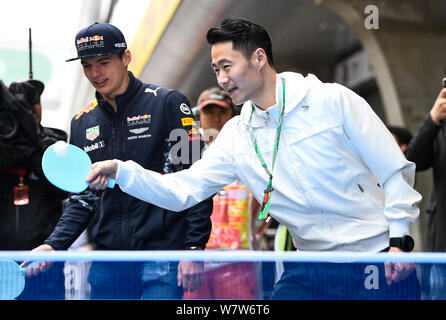 Retired Chinese table tennis player Wang Liqin, right, instructs Dutch F1 driver Max Verstappen of Red Bull Racing ahead of the 2017 Formula One Chine Stock Photo