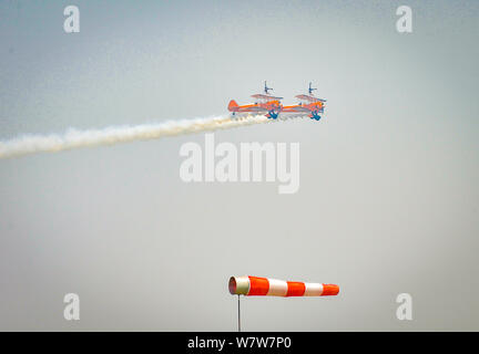 British aerobatics and wingwalking team AeroSuperBatics perform the acrobatics on a flying plane during the 2017 Zhengzhou Airshow in Zhengzhou city, Stock Photo