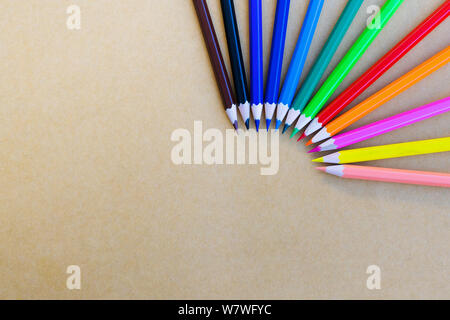 variety different color pencils on yellow background Stock Photo
