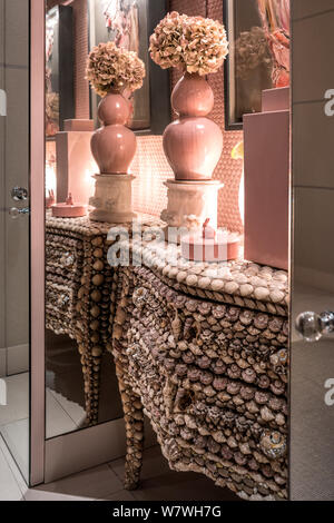Seashell covered drawers in pink niche Stock Photo