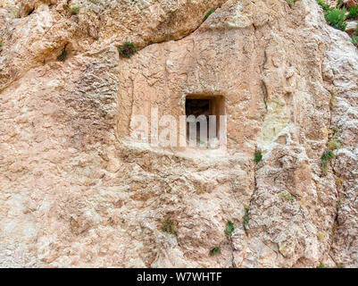 Aerial view of bas-reliefs carved in the rock that adorn the entrance frame of a house carved into the rock on the steep side of a mountain. Turkey Stock Photo