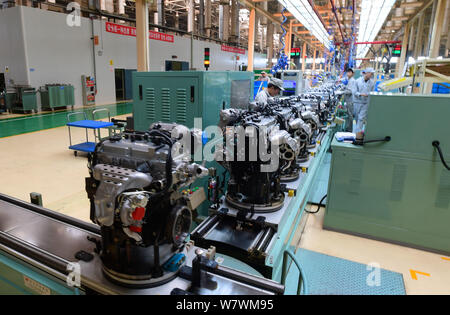 --FILE--A Chinese worker assembles engines on the assembly line at an ...